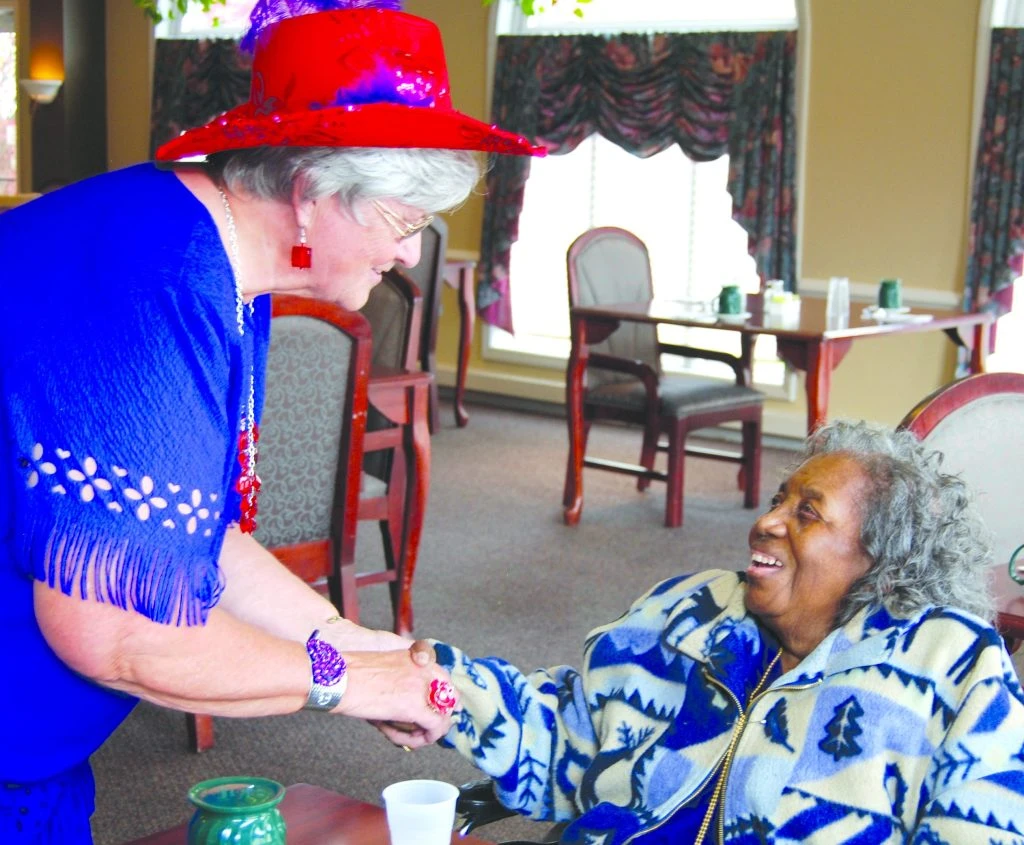 A performer shakes a woman's hand