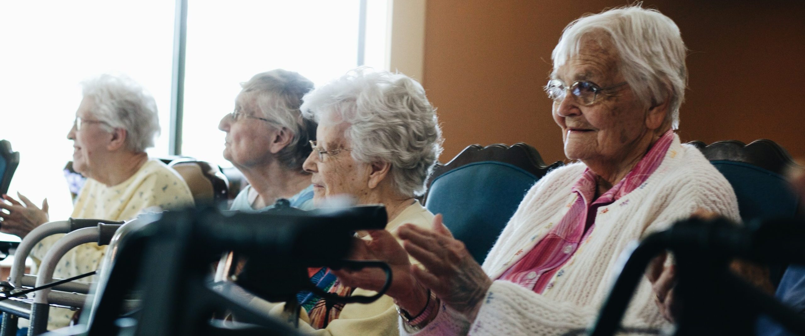 Seniors clap along to a performance